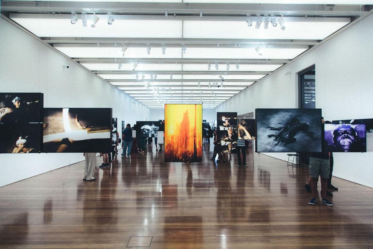 Visitors looking at artwork in an exhibition