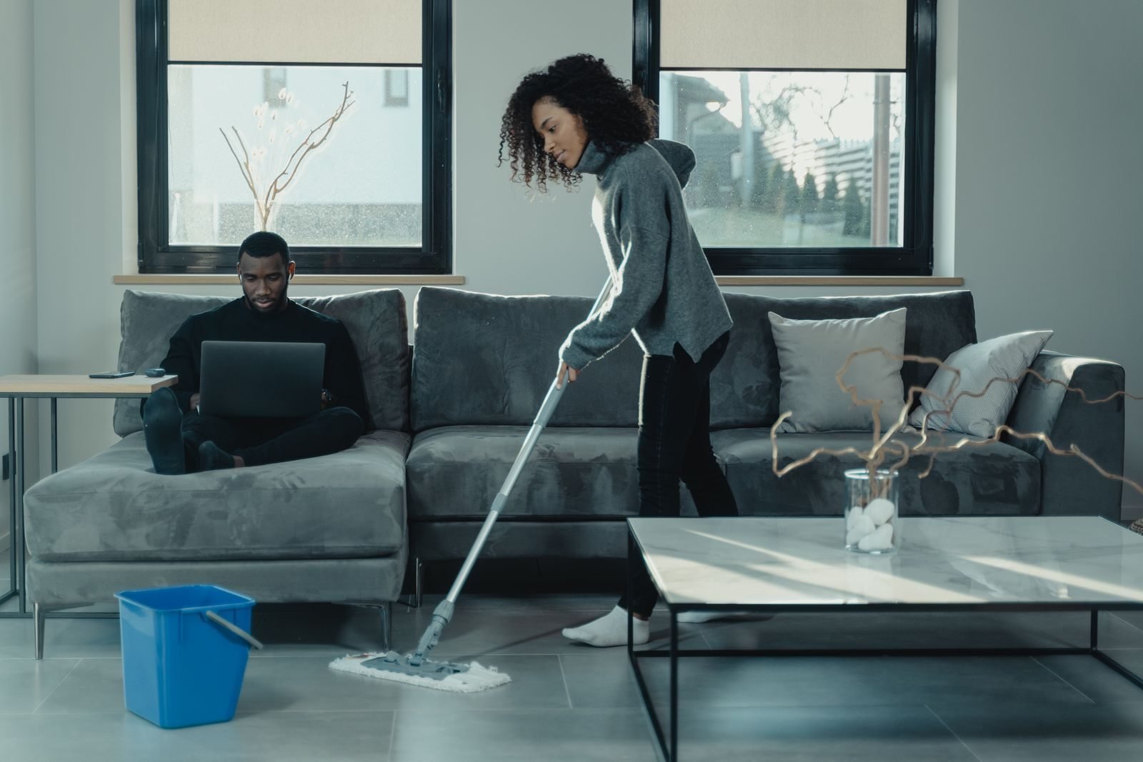 Woman cleaning a floor with a mop