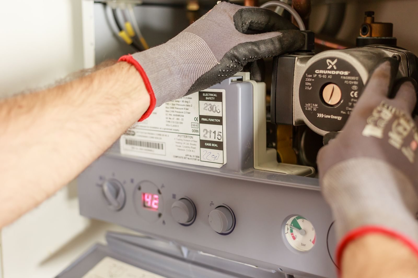 Technician adjusting a residential heating system