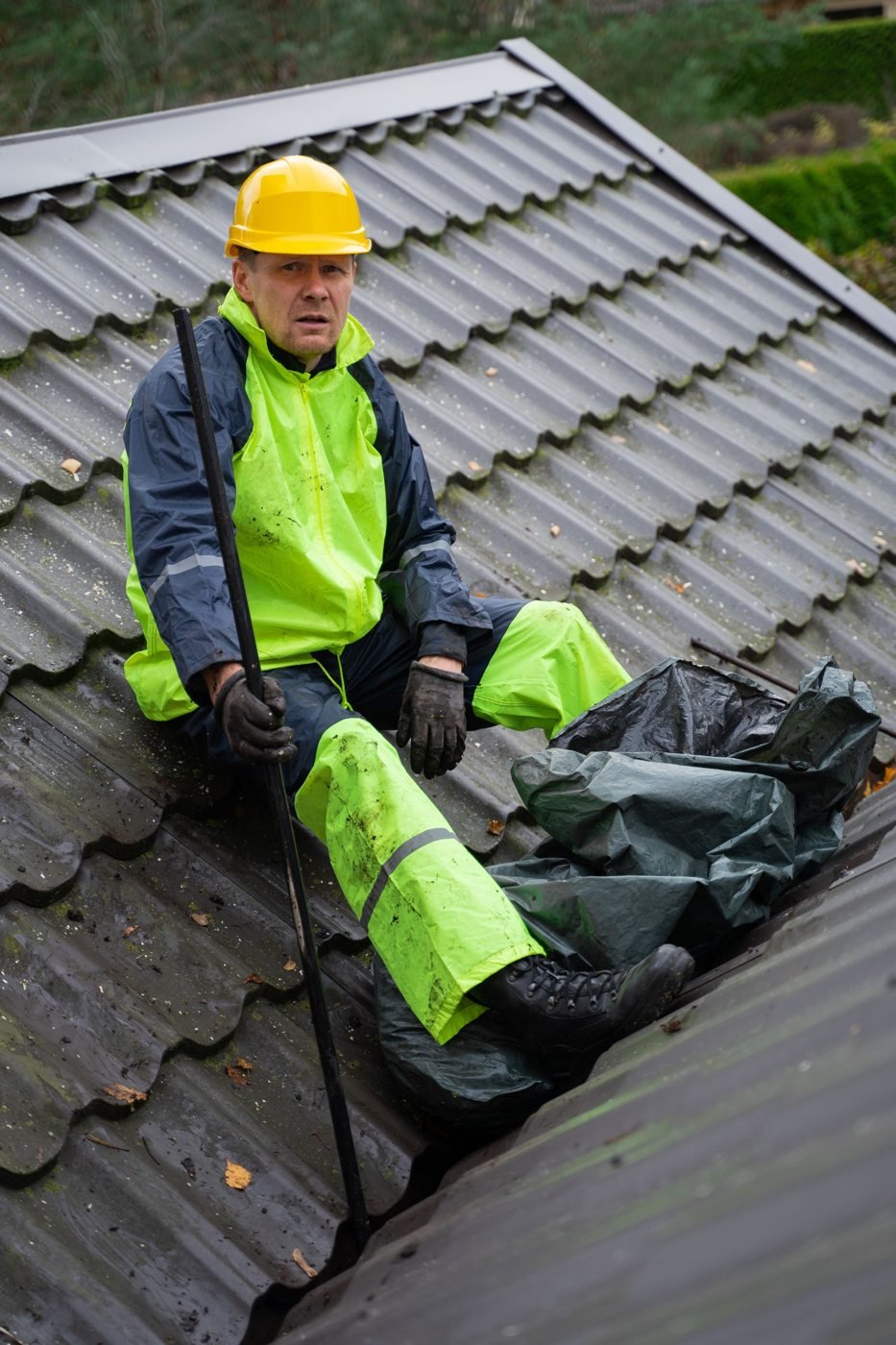 Roofing specialist inspecting a home roof